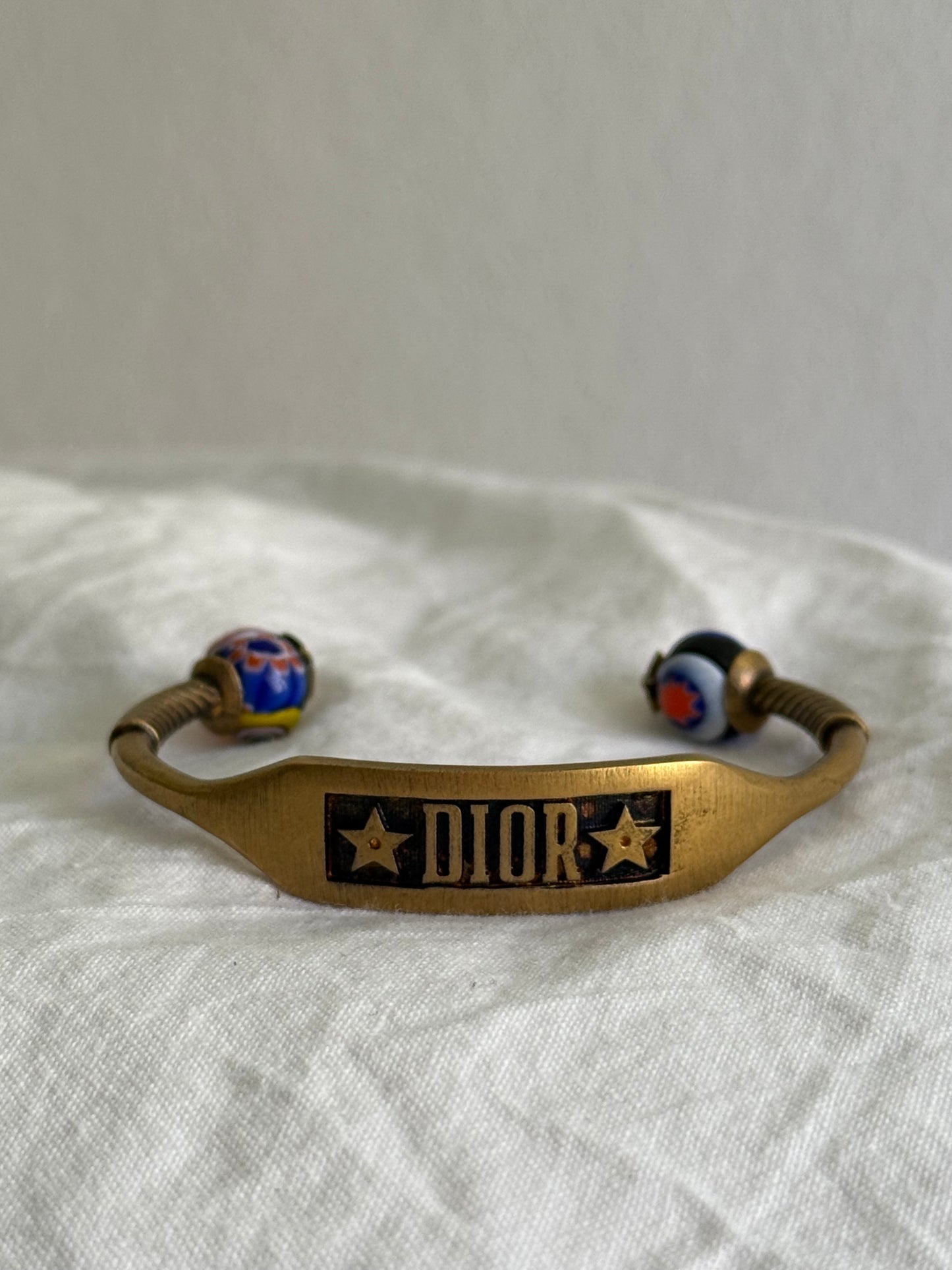 Dior Logo Cuff Bracelet With Star Detail in Antique Gold-Finish Metal